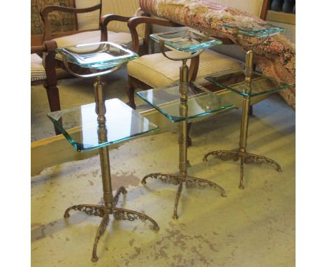 STANDS, a set of three, brass framed, each with a green glass dished top and a shelf below, 30cm W x 71cm H. (3)