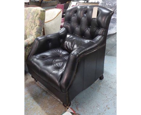 LIBRARY ARMCHAIR, Victorian style in black buttoned leather with scatter cushion on bun legs with castors, 80cm W.