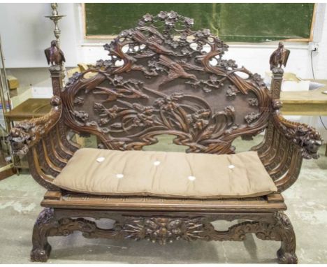 HALL BENCH, 19th century Chinese lacquer with bird, foliate and dragon carved decoration, panel seat and squab cushion, 129cm