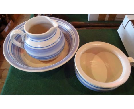 A Poole Pottery Picotee glazed washbowl, jug and chamber pot, each decorated in shades of blue, impressed mark and incised sh