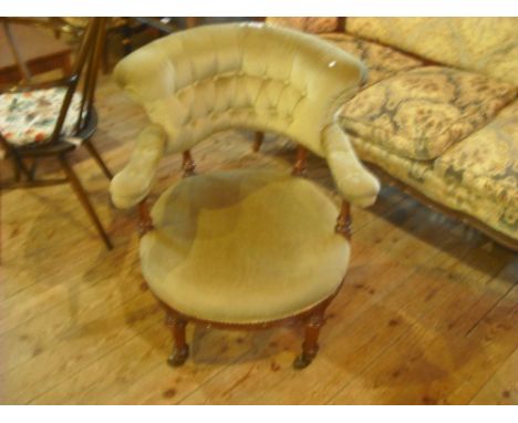A late Victorian button back green upholstered tub chair on turned supports (63cm).