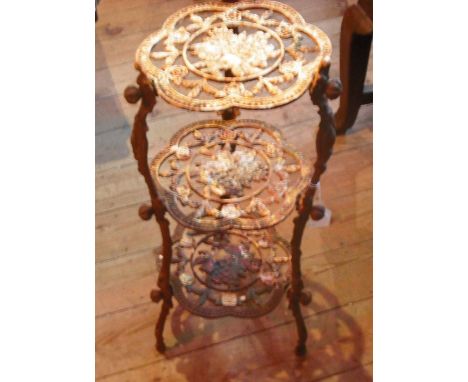 A Victorian ebonised corner display unit, having four mirror panels over two open shelves (62cm wide).