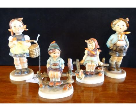 Four Hummel figurines, to include: a pair numbered 1938, a Whistling Boy no. 95 and a Girl with a Basket, no. 98/0.