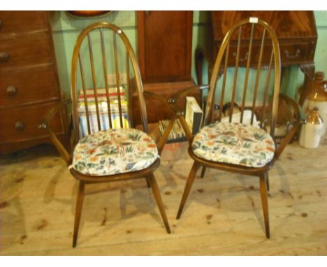 A pair of ercol carver dining chairs (61cm wide).