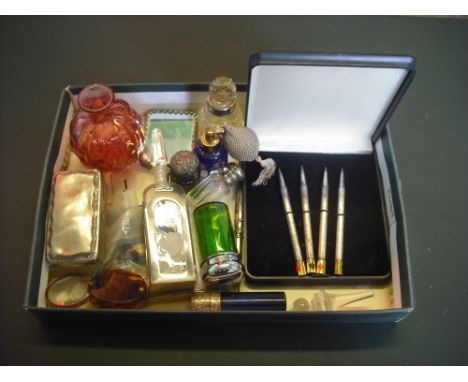 A mixed lot to include: a cased set of white metal bridge pens, a quantity of late Victorian coloured glass scent bottles, a 