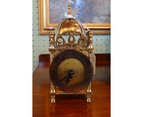 A brass cased lantern clock (18cm).