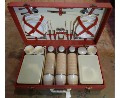 A mid-20th century Brexton cased travelling picnic set, to include: three flasks, two sandwich boxes, cups, saucers and plate