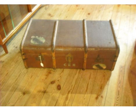 A large wood bound cabin trunk, early 20th century, having two exterior shipping labels (91cm wide).