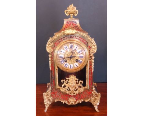 A 19th century French Boulle work mantle clock, the movement numbered 5847, the urn finial over curved top, the dial set with