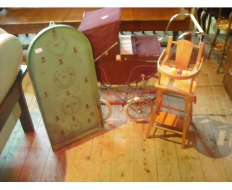 A circa 1950's child's doll pram, together with a doll's highchair and a green painted bagatelle board with original ball bea