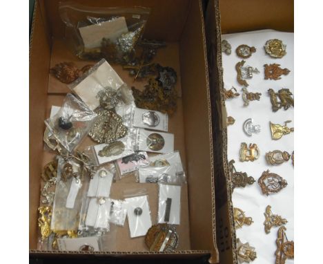 A quantity of early 20th century and later Military cap and uniform badges, to include some enamel examples. Condition Report