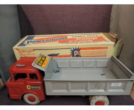 A Marx Magic Marxie Toy tin plate and friction driven Powerhouse Dump Truck having red cab with decals, grey tipper with deca