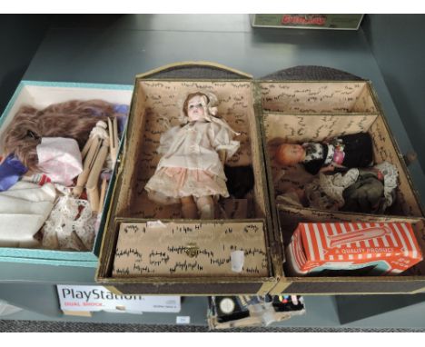 A early 20th century SFBJ bisque headed doll having fixed open eyes, open mouth with four teeth showing, jointed composition 