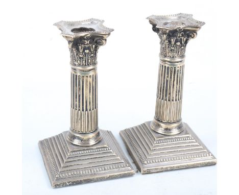 A pair of Edwardian silver Corinthian column table candlesticks, with removable sconces, by James Charles Jay, hallmarks Lond