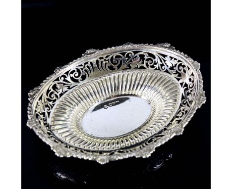 An Edwardian silver bon bon dish, oval form with gadrooned rim, pierced foliate border and fluted decoration, by Josiah Willi