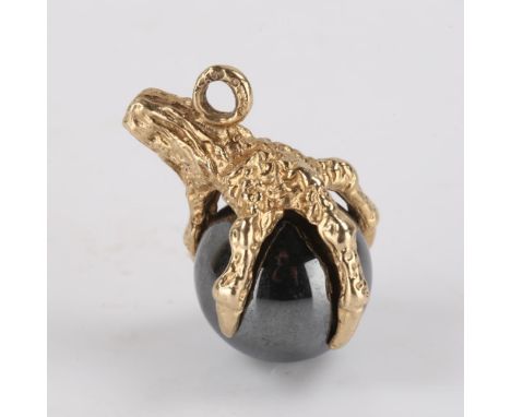 A late 20th century 9ct gold hematite figural claw and ball charm, hallmarks London 1990, length 22mm, 7.4gNo damage or repai