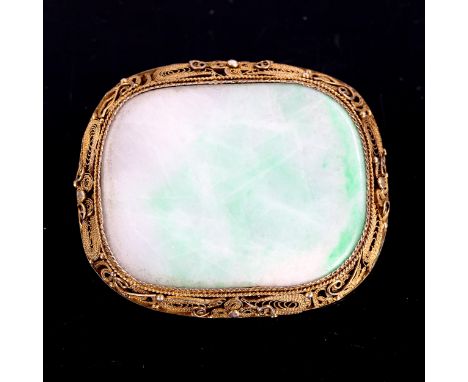 A Chinese silver gilt jade panel brooch, polished tablet form with wirework filigree frame, brooch length 47.8mm, 18gNo damag