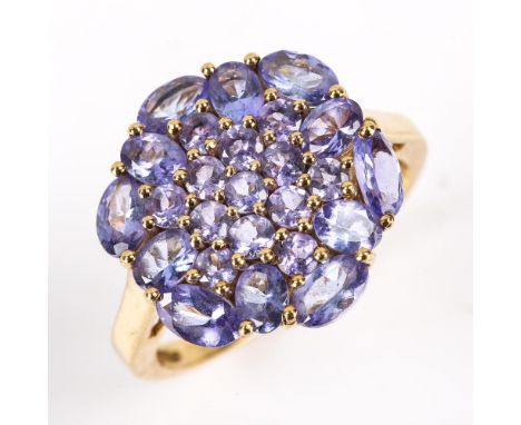 A modern 9ct gold tanzanite cluster ring, set with oval mixed and round cut tanzanites, setting height 17.5mm, size R, 4.4gNo