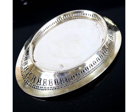 A late Victorian silver desk stand, oval form with pierced gallery, and removable silver-mounted glass inkwell, by Wakely & W