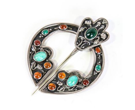A Scottish Celtic stone set penannular brooch, unmarked white metal settings with cabochon stones and stylised floral decorat