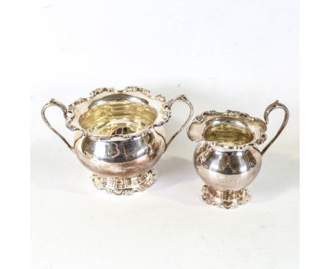 An Edwardian silver matching sugar bowl and cream jug, bulbous form with cast floral rim, by Martin, Hall & Co, hallmarks She