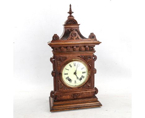 An early 20th century German oak-cased 8-day architectural mantel clock, by Lenzkirch, cream enamel dial with Roman numeral h