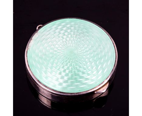 An Art Deco Continental silver and green enamel compact, engine turned decoration with gilt interior, diameter 4.5cmEnamel ha