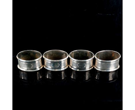 A set of 4 Art Deco George V oval silver napkin rings, engine turned decoration, by Jones & Crompton, hallmarks London 1927, 