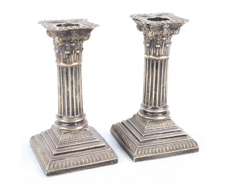 A pair of Victorian silver Corinthian column table candlesticks, by Goldsmiths and Silversmiths Co, hallmarks London and Shef