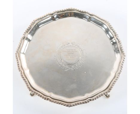 A George V silver salver, circular form with gadrooned rim and four hoof feet, masonic presentation engraving by the Abbey Lo