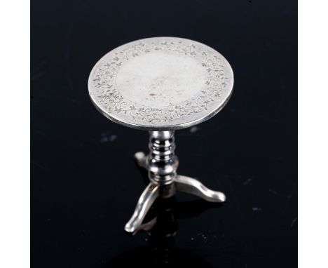 An early 20th century Chinese Export silver miniature dolls tripod table, engraved floral decoration, possibly by Luen Wo of 