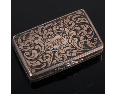 A Victorian silver niello vinaigrette, rectangular form with allover engraved foliate decoration and cast thumb-piece, gilt i