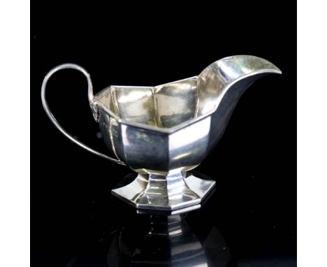 A George V silver pedestal sauce boat, octagonal form, by Robert Stewart, hallmarks London 1916, length 17.5cm, height 10cm, 