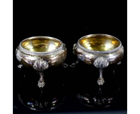 A pair of Victorian silver salt cellars, beaded edge with hoof feet and gilt interior, by James Beebe, hallmarks London 1863,