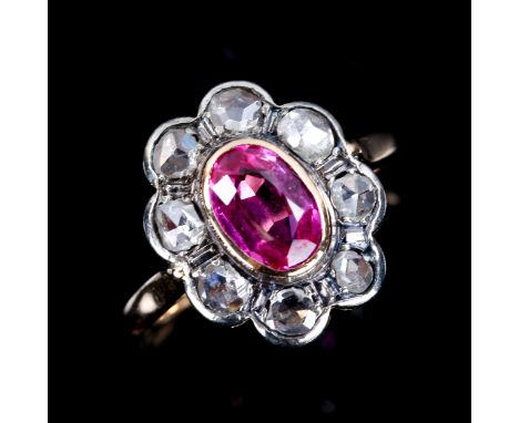 An 18ct gold synthetic ruby and diamond cluster ring, set with oval mixed cut ruby and rose cut diamonds, ruby has not been l