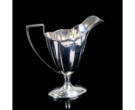 A late Victorian silver helmet-shaped pedestal cream jug, reeded edge and handle, by Thomas Hayes, hallmarks Birmingham 1898,