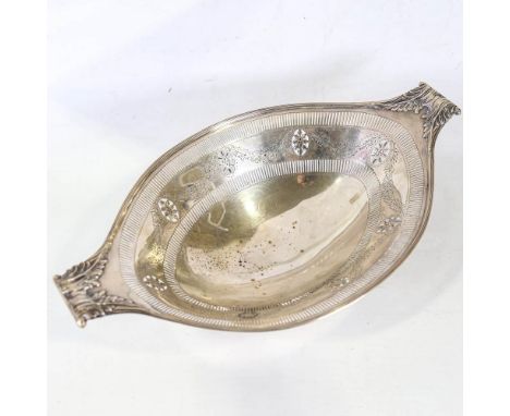 A large Edwardian silver pedestal cake basket, cast scrolled acanthus leaf handles with reeded rim, pierced border and engrav
