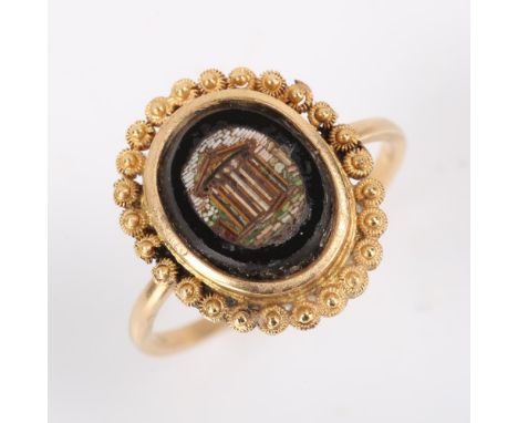 An Antique Grand Tour micro mosaic panel dress ring, depicting ruins within a cannetille surround, setting height 18mm, size 