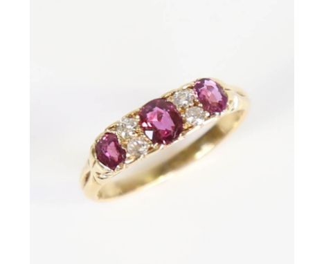 An early 20th century 18ct gold 7-stone ruby and diamond half hoop ring, set with oval mixed cut rubies and old cut diamonds,