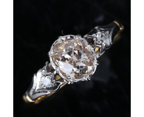 An 18ct gold 0.7ct solitaire diamond ring, set with oval old cut diamond and single cut diamond platinum topped floral should