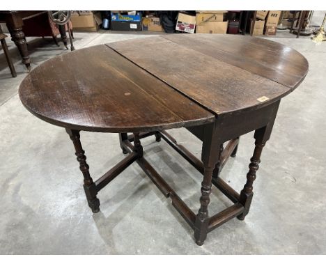 A joined oak dropleaf table raised on ring and bobbin turned legs. 36½' wide. Elements late 17th century 