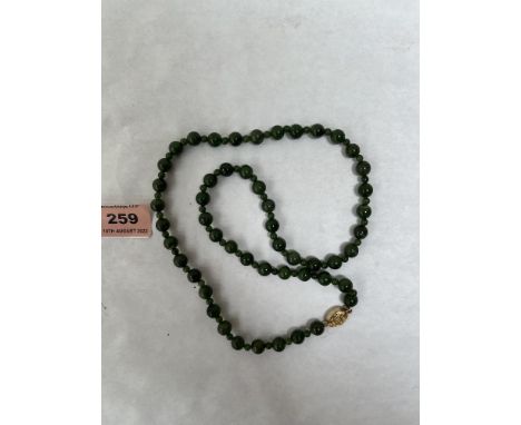 A necklace of jade beads. 23' long