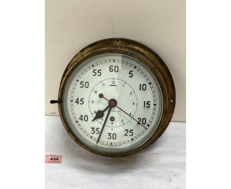 A brass maritime bulkhead clock with key wound movement, the enamel dial with Arabic numerals and sweep seconds. 10¼' diam.