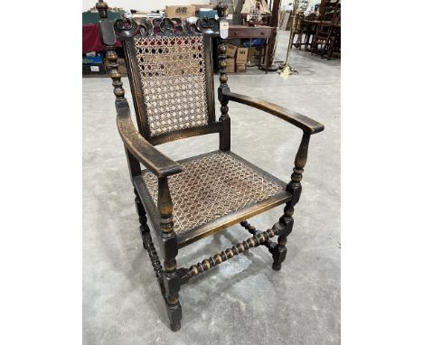 An oak bobbin turned elbow chair with caned back and seat