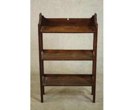 An Arts &amp; Crafts oak book shelf, the gallery back with spade detail, over three shelves on square section legs. H.89 W.59