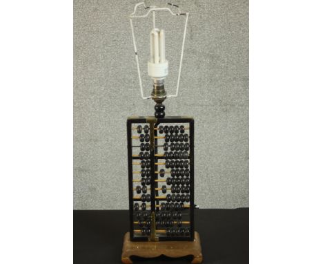 A vintage Chinese abacus table lamp on carved base, with cream fabric shade. H.55 W.18 D.12cm. 