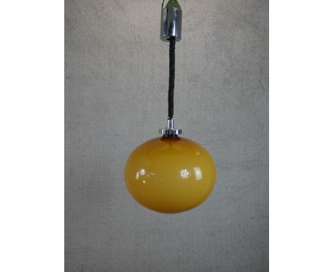 A 1970’s Rolly Brevettato pendant light with amber glass globe shade. H.57cm 