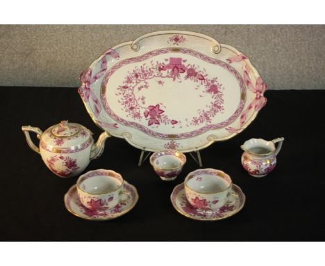 A hand painted Herend porcelain cabaret tea set in the pink Chinese Bouquet pattern, with teapot, two cups and saucers, milk 