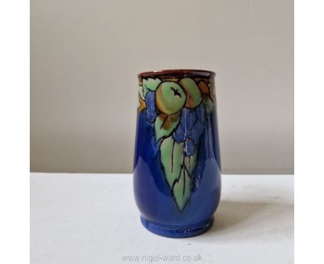A Royal Doulton Lambeth art deco vase painted with apples and grapes in low relief against a blue ground incised initials AL 