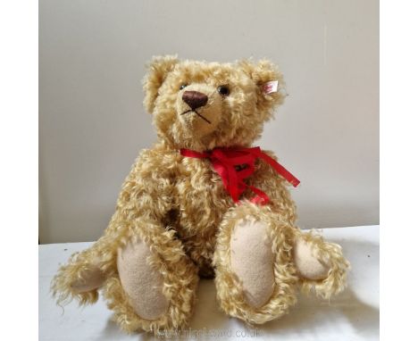 A Steiff teddy bear with button, label and growler, 13 ins high (sitting).